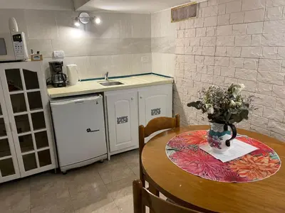 a kitchen with a table with a vase of flowers on it at CERRO CHICO APART in Cordoba