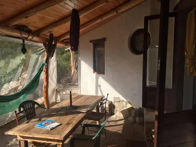 a wooden table and chairs in a room at Refugio: El Llamado in Villa de Las Rosas