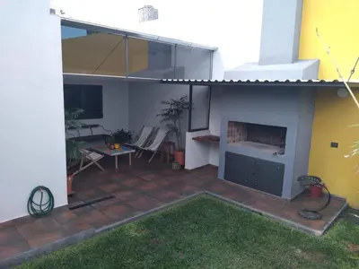a patio with a fireplace in a house at Casa confortable in Cordoba