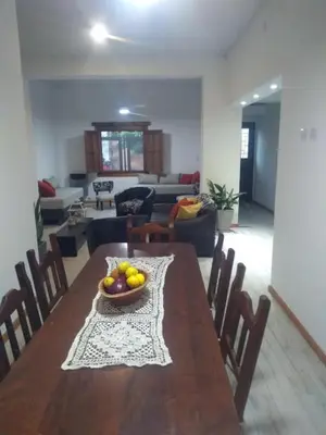 a dining room table with a bowl of fruit on it at Casa confortable in Cordoba