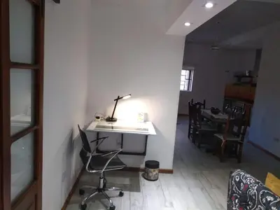 a room with a desk and a chair and a table at Casa confortable in Cordoba