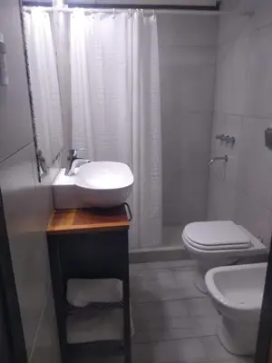 a bathroom with a sink and a toilet and a shower at Casa confortable in Cordoba