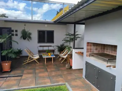a patio with chairs and a table and a fireplace at Casa confortable in Cordoba