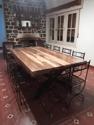 a large wooden table in a room with chairs at Casa de Montaña in Cordoba