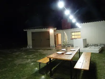 a picnic table in a yard at night at Casa de Montaña in Cordoba