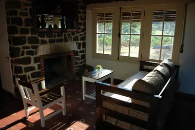 a living room with a couch and a fireplace at Casa de Montaña in Cordoba