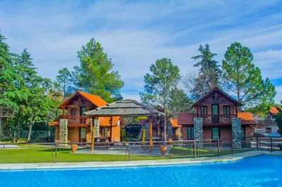 a house with a pool and a playground at Hotel Villa Sol in Merlo