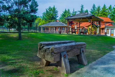 a wooden bench in a park with a playground at Hotel Villa Sol in Merlo
