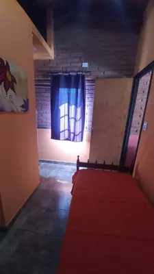 a room with a red carpet and a window at Mardi - Departamentos de alquiler temporario in Bialet Massé