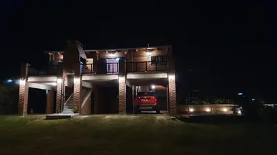 a car parked in front of a house at night at Mardi - Departamentos de alquiler temporario in Bialet Massé