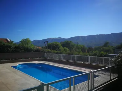 a swimming pool on top of a house at Mardi - Departamentos de alquiler temporario in Bialet Massé