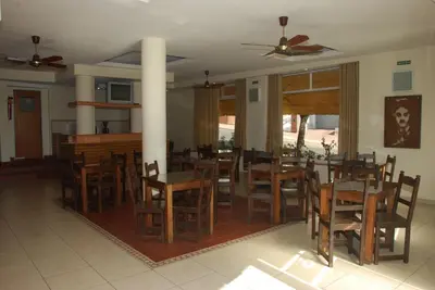 a dining room with wooden tables and chairs at Hotel Gran Crisol in Cordoba