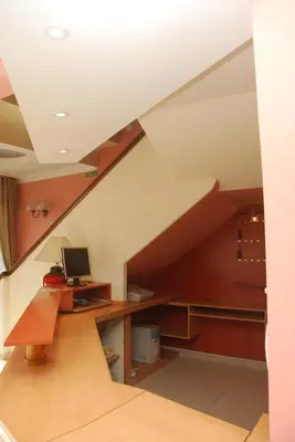 a staircase with a desk and a computer in a room at Hotel Gran Crisol in Cordoba