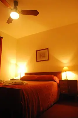 a bedroom with a bed with two lamps on it at Hotel Gran Crisol in Cordoba