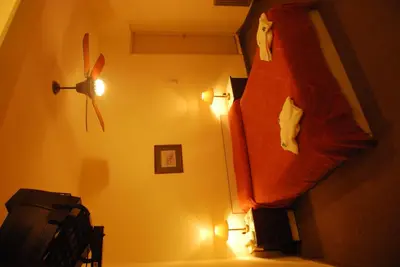 a bedroom with a comforter hanging on the wall at Hotel Gran Crisol in Cordoba