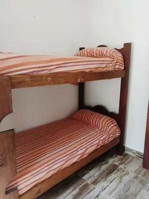 two bunk beds sitting next to a wall at Casa Roma in Villa Carlos Paz