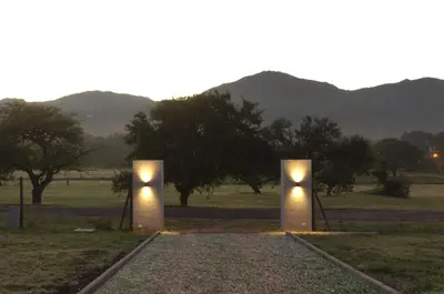 two lights in a field with mountains in the background at Los Cóndores Aparts. in Villa General Belgrano