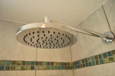 a shower with a shower head in a bathroom at Los Cóndores Aparts. in Villa General Belgrano