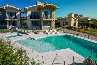 a swimming pool in front of a villa at Los Cóndores Aparts. in Villa General Belgrano