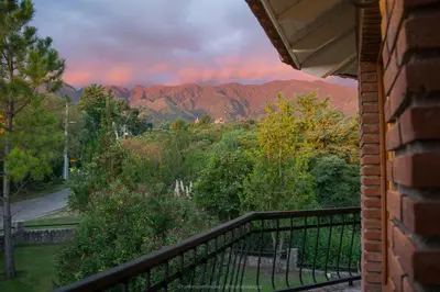 a balcony of a house with a view of the mountains at La Barraca Resort in Merlo