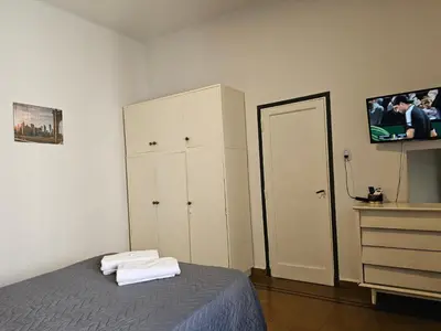 a bedroom with a bed and a dresser and a mirror at LitStay Paso de los Andes PB in Cordoba