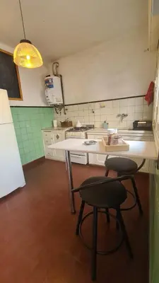 a kitchen with two stools and a table in it at LitStay Paso de los Andes PB in Cordoba