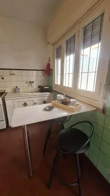 a kitchen with a table and a chair in it at LitStay Paso de los Andes PB in Cordoba