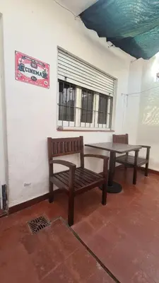 two benches and a table in a room at LitStay Paso de los Andes PB in Cordoba