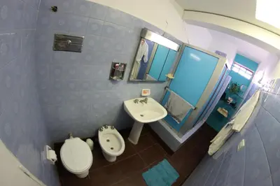 a small bathroom with a toilet and a sink at Casa Alberdi in Cordoba