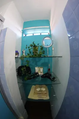 a small bathroom with a mirror and a sink at Casa Alberdi in Cordoba