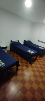 a room with two beds sitting on a floor at La Casa de Elisa in Santa Rosa de Calamuchita