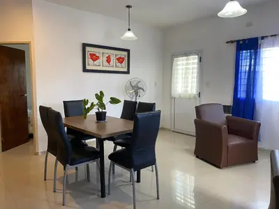 a dining room with a table and chairs at Apartamentos Anahí in Villa Parque Siquiman