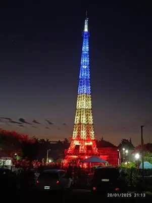 a lit up eiffel tower at night at Apartamentos Anahí in Villa Parque Siquiman