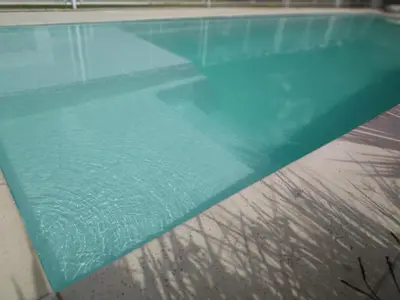 an empty swimming pool with a turquoise at Ayres de Merlo Aparts in Merlo
