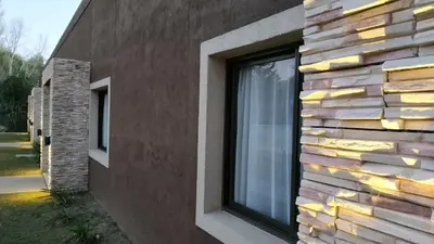 a window on the side of a house at Ayres de Merlo Aparts in Merlo