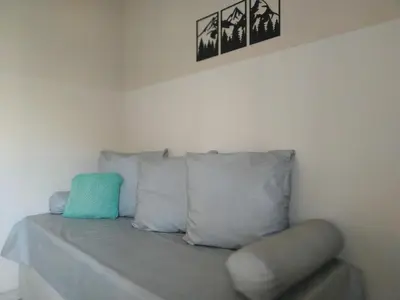 a couch in a room with pillows and a chair at Ayres de Merlo Aparts in Merlo
