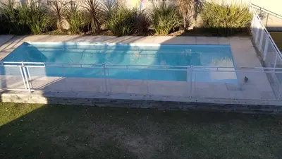 a swimming pool with a fence around it at Ayres de Merlo Aparts in Merlo
