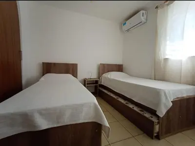 two twin beds in a room with a window at Apartamentos Santa Rosa PB 1 in Cordoba