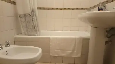a bathroom with a sink and a tub and a toilet at Apartamentos Santa Rosa PB 1 in Cordoba