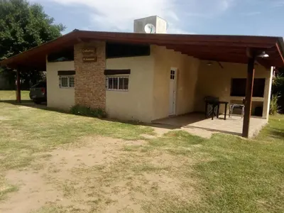 a small house with a table in front of it at El Amanecer in Santa Rosa de Calamuchita