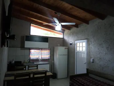 a kitchen with a ceiling fan and a refrigerator at El Amanecer in Santa Rosa de Calamuchita