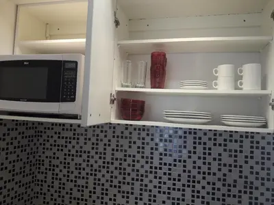 a microwave oven sitting inside of a kitchen cabinets at Departamento Torre Sofitel in Río Cuarto