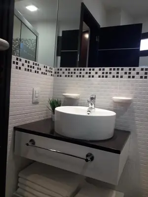 a bathroom with a sink and a mirror at Departamento Torre Sofitel in Río Cuarto