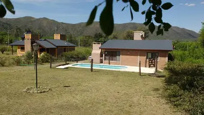 a house with a swimming pool in front of a house at Postal de las Sierras in Santa Rosa de Calamuchita