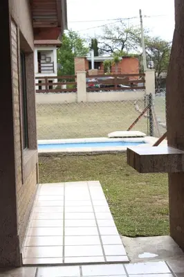 an outside view of a yard with a pool and a house at Postal de las Sierras in Santa Rosa de Calamuchita
