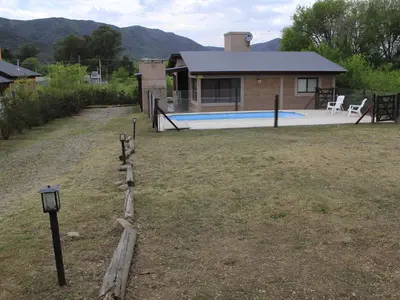 a house with a swimming pool in a yard at Postal de las Sierras in Santa Rosa de Calamuchita