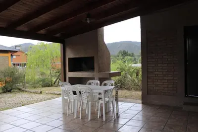 a white table and chairs on a patio at Postal de las Sierras in Santa Rosa de Calamuchita