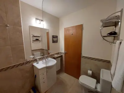 a bathroom with a sink and a toilet and a mirror at Le Bel-Edén in Villa General Belgrano