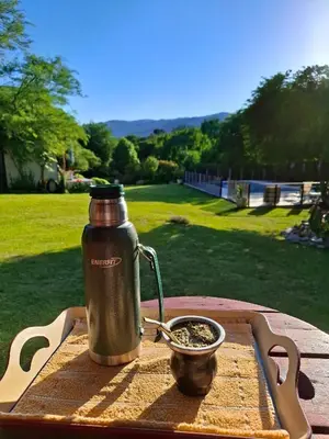 a bottle of water and a bowl on a table at Le Bel-Edén in Villa General Belgrano