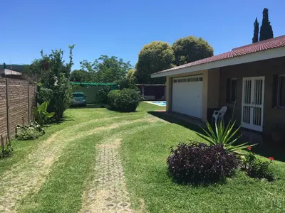 a driveway to a house with a garage at Departamento Carlos paz in Villa Carlos Paz